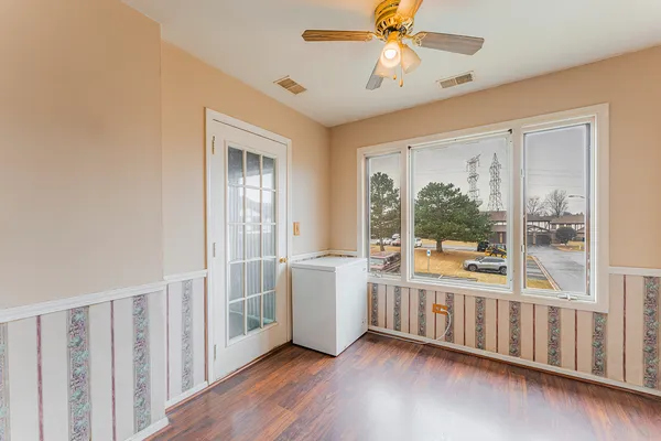 a large room with wooden floor and windows