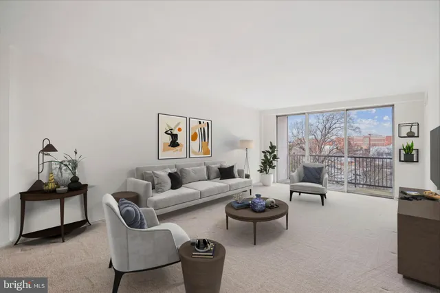 a living room with furniture and a floor to ceiling window