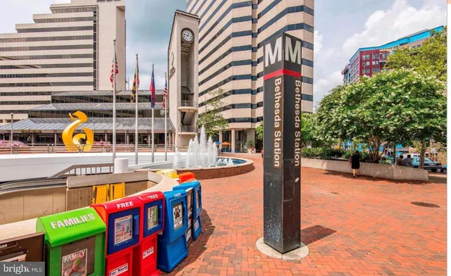 a front view of multi story building with retail shops