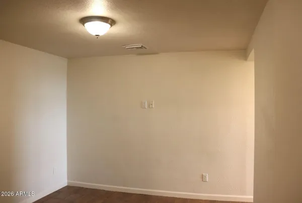 a view of a room with wooden floor