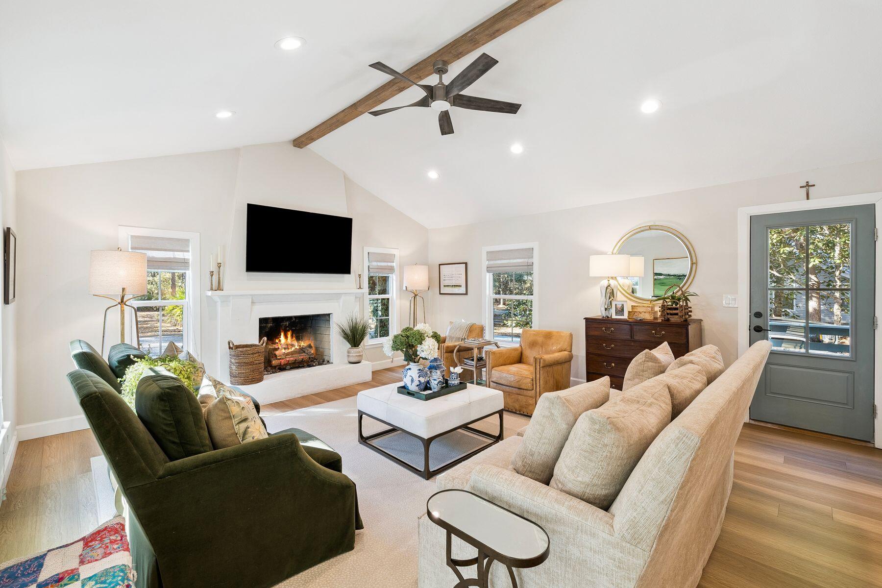 1525 West Hewett Road Santa Rosa Beach, FL 32459 - Photo 2 of 56 a living room with furniture a fireplace and a flat screen tv