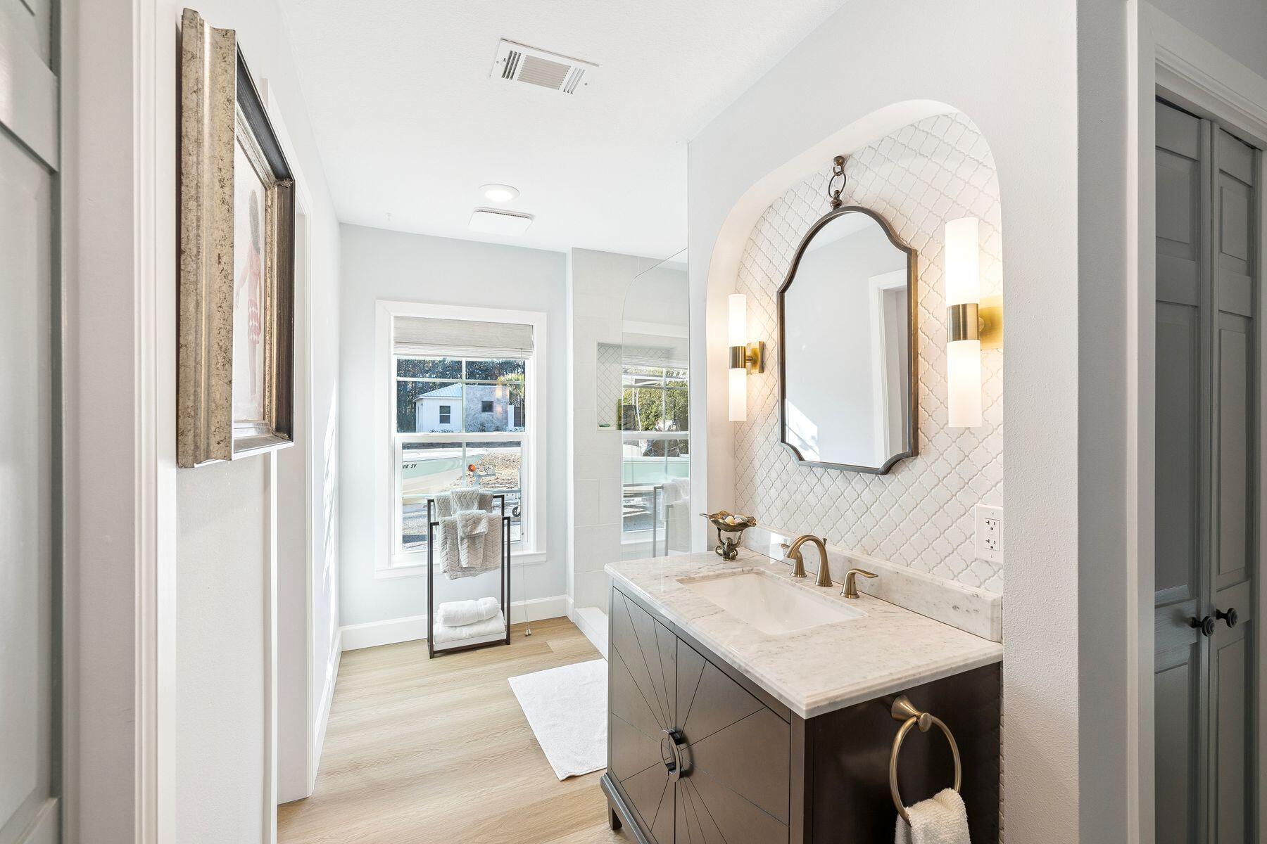 1525 West Hewett Road Santa Rosa Beach, FL 32459 - Photo 27 of 56 a en suite bathroom with a granite countertop sink and a mirror