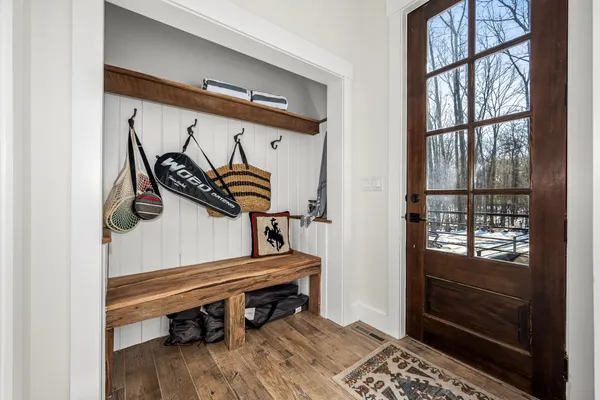 a spacious bedroom with a bed a mirror with the walls