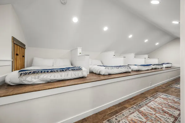 a bedroom with a bed furniture and a flat screen tv