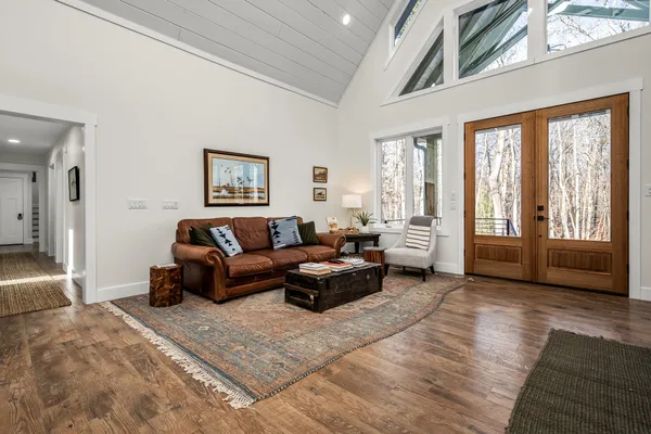 a living room with furniture and large windows