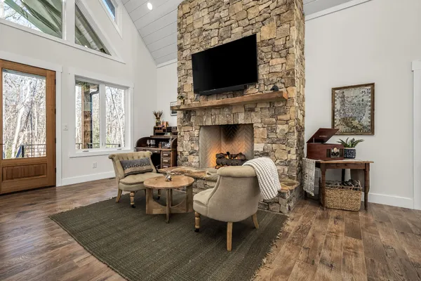a living room with furniture a flat screen tv and a fireplace
