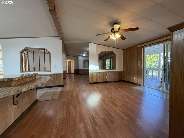 a kitchen with a stove a refrigerator and white cabinets