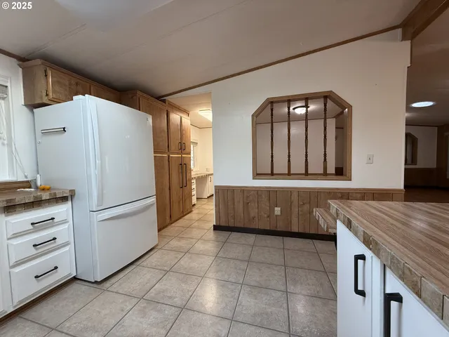 a hallway view with staircase and a mirror