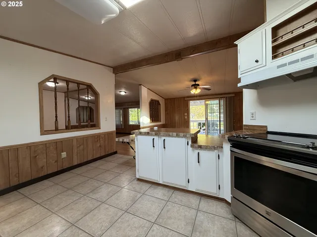 a kitchen with a stove and white cabinets