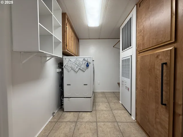 a kitchen with a sink and large windows