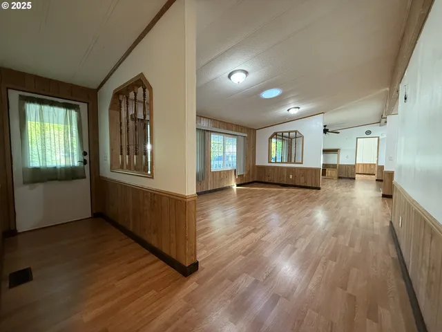 a view of a room with wooden floor and windows