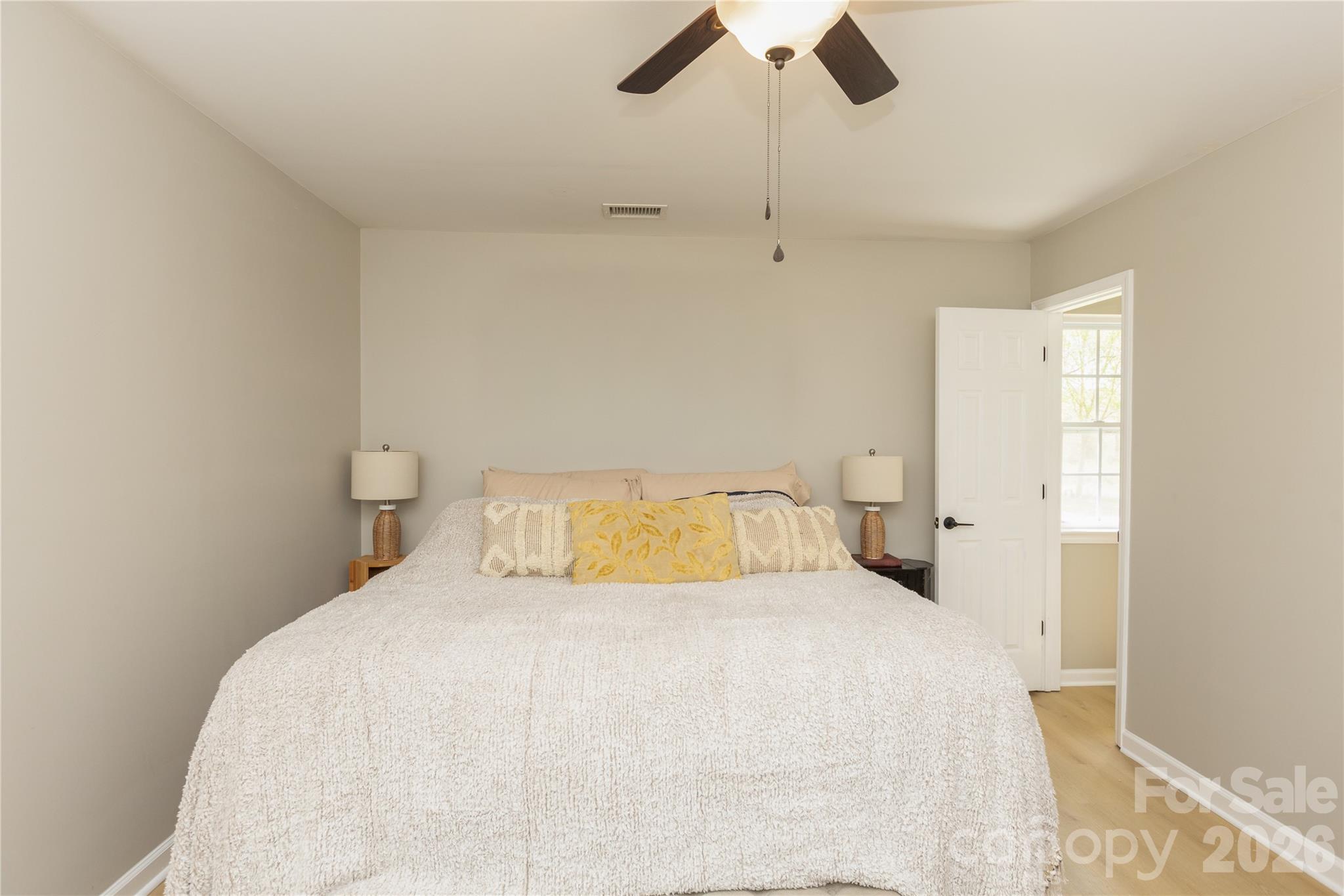 5126 Monroe-Ansonville Road Wingate, NC 28174 - Photo 18 of 28 a bedroom with a bed and a ceiling fan