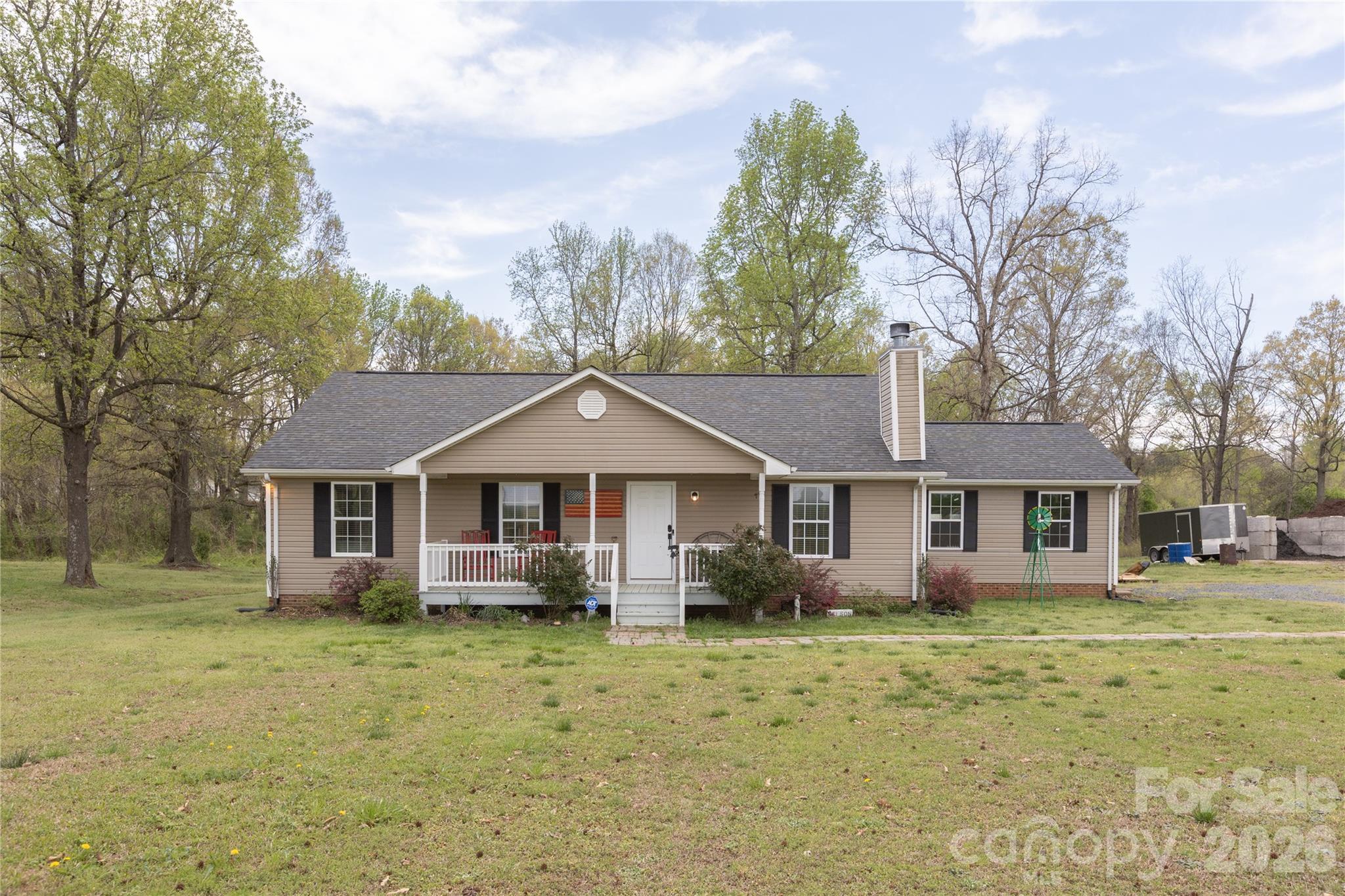 5126 Monroe-Ansonville Road Wingate, NC 28174 - Photo 2 of 28 a view of a yard in front of a brick house with large windows