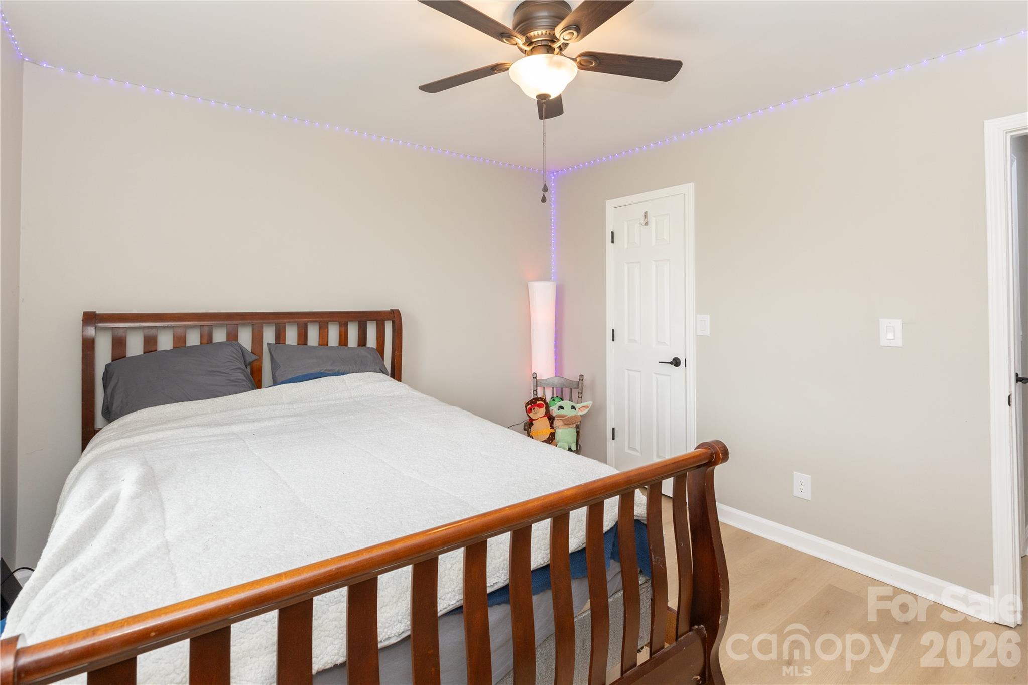 5126 Monroe-Ansonville Road Wingate, NC 28174 - Photo 23 of 28 a bedroom with a bed and a chandelier