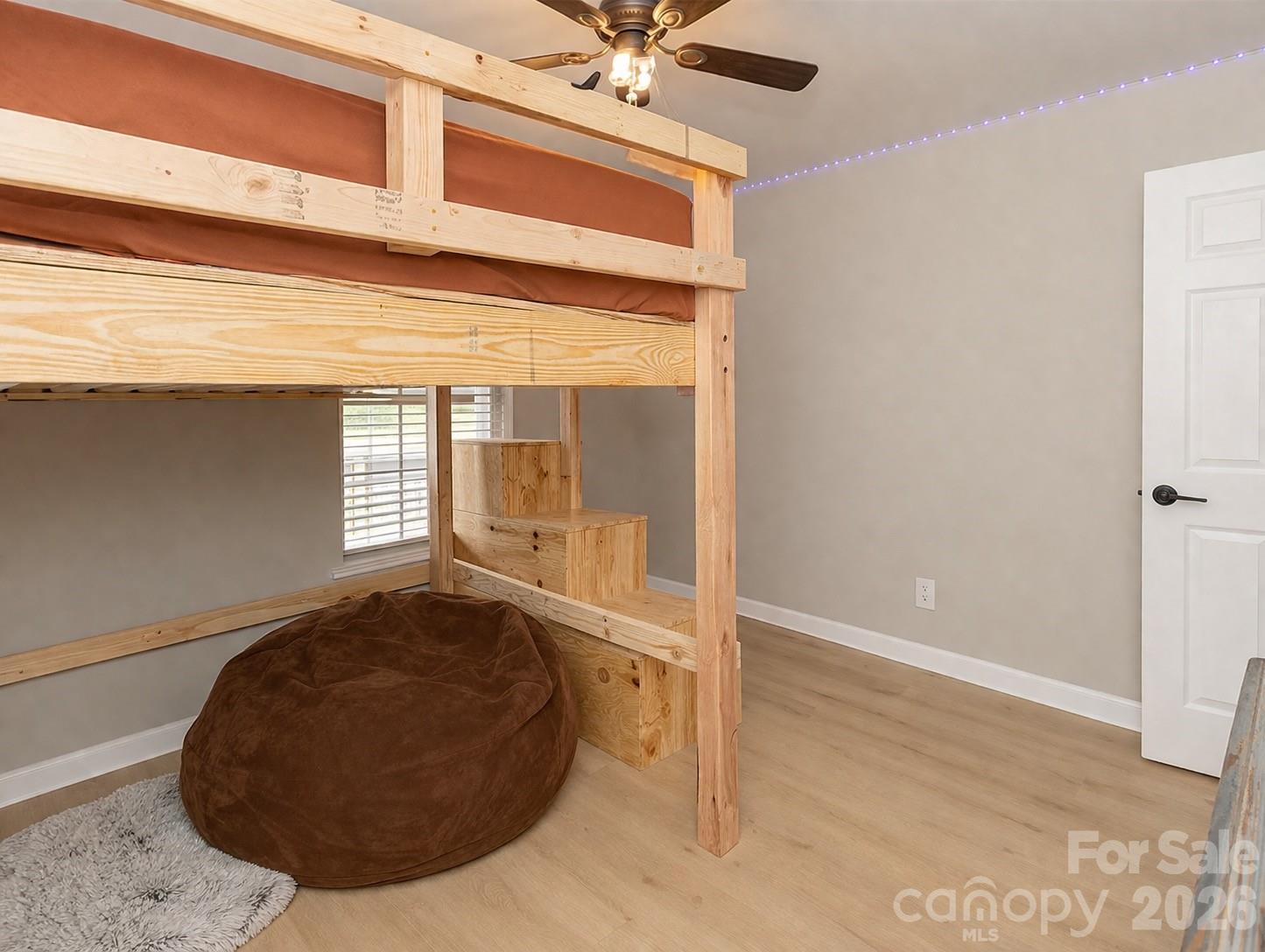 5126 Monroe-Ansonville Road Wingate, NC 28174 - Photo 24 of 28 a view of a livingroom with wooden floor and a ceiling fan