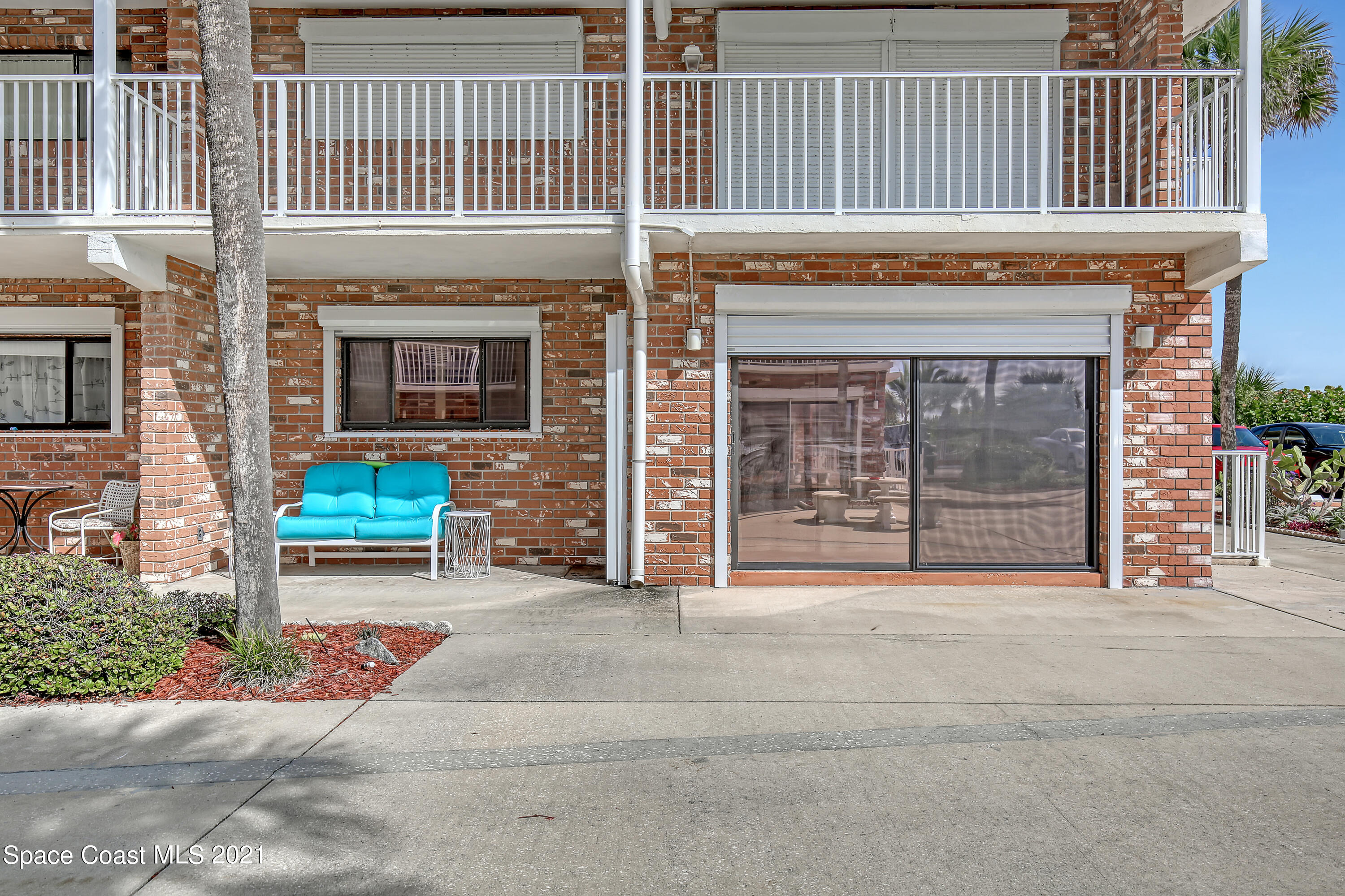 5000 Ocean Beach Boulevard, Unit C5 Cocoa Beach, FL 32931 - Photo 2 of 43 a view of a house with a yard and large window