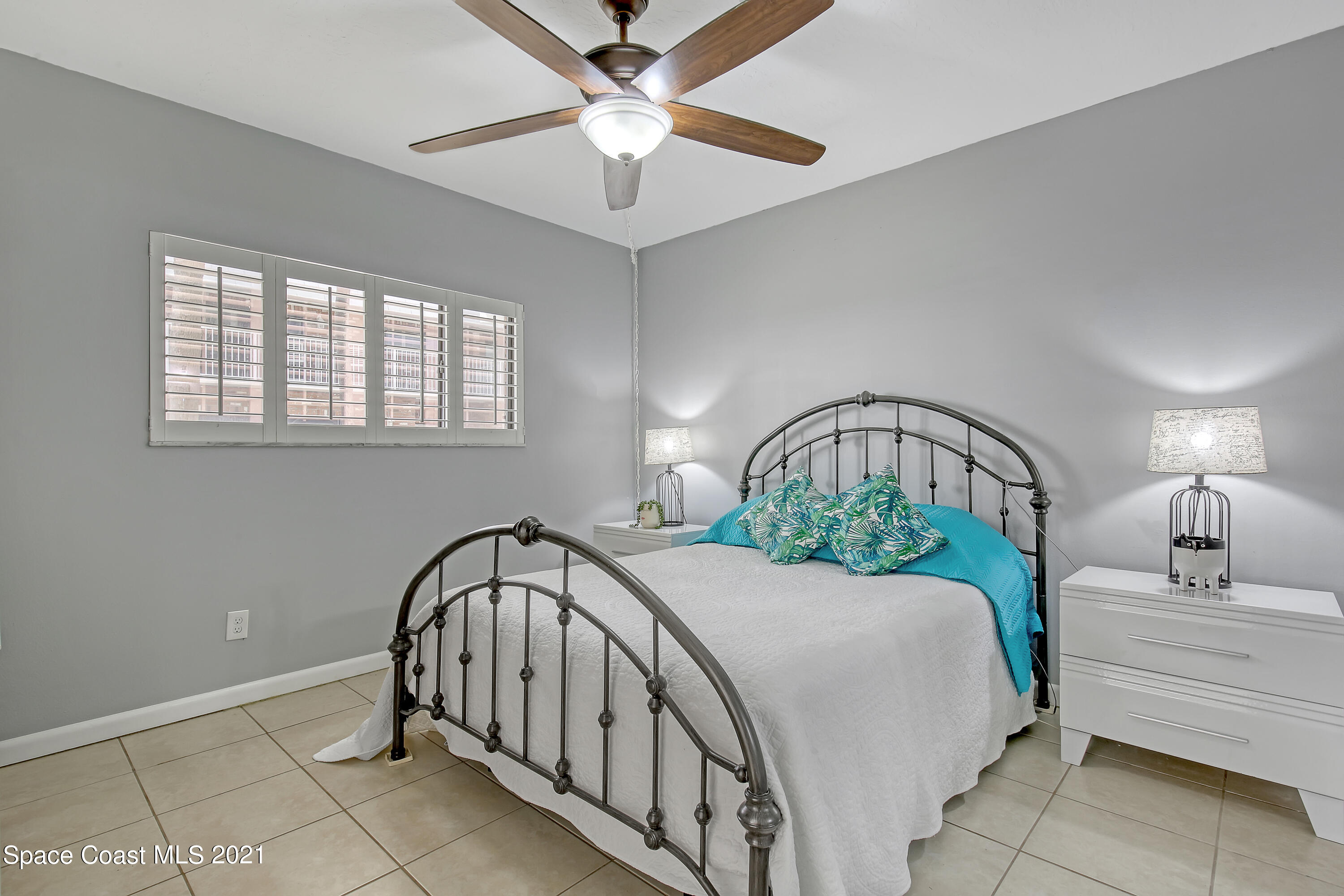 5000 Ocean Beach Boulevard, Unit C5 Cocoa Beach, FL 32931 - Photo 17 of 43 a bedroom with a bed and a chandelier