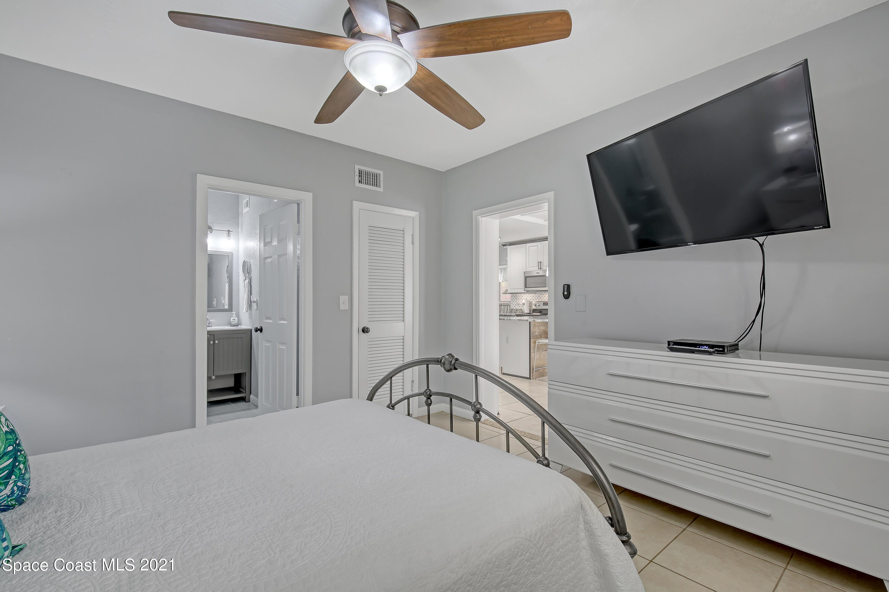 5000 Ocean Beach Boulevard, Unit C5 Cocoa Beach, FL 32931 - Photo 18 of 43 a bedroom with a bed and a flat screen tv