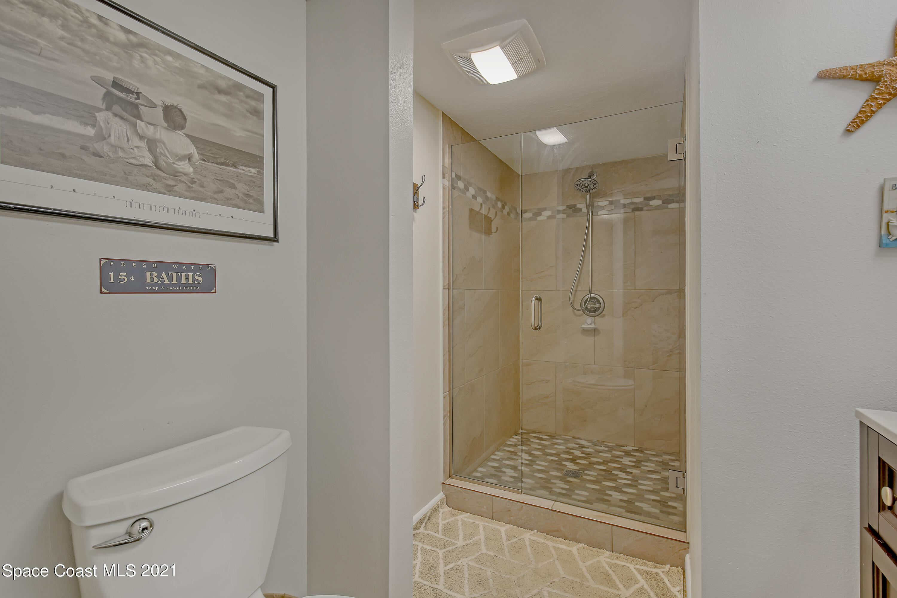 5000 Ocean Beach Boulevard, Unit C5 Cocoa Beach, FL 32931 - Photo 23 of 43 a bathroom with a shower and toilet