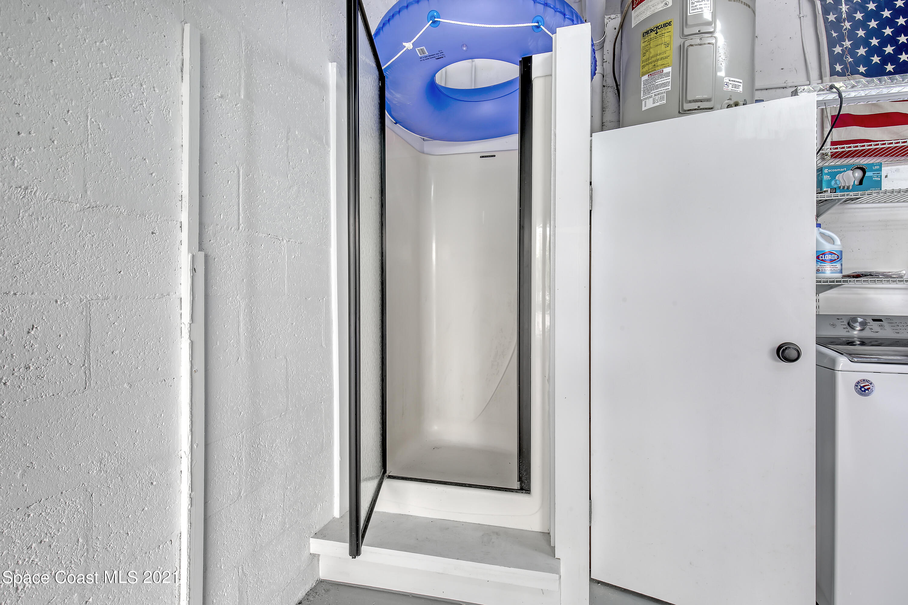 5000 Ocean Beach Boulevard, Unit C5 Cocoa Beach, FL 32931 - Photo 26 of 43 a bathroom with a granite countertop mirror and a shower