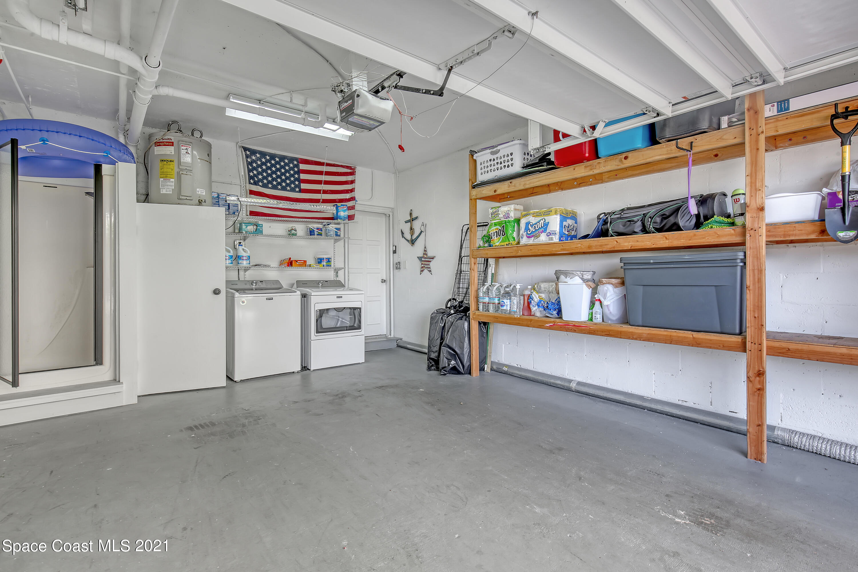 5000 Ocean Beach Boulevard, Unit C5 Cocoa Beach, FL 32931 - Photo 27 of 43 a utility room with dryer and washer