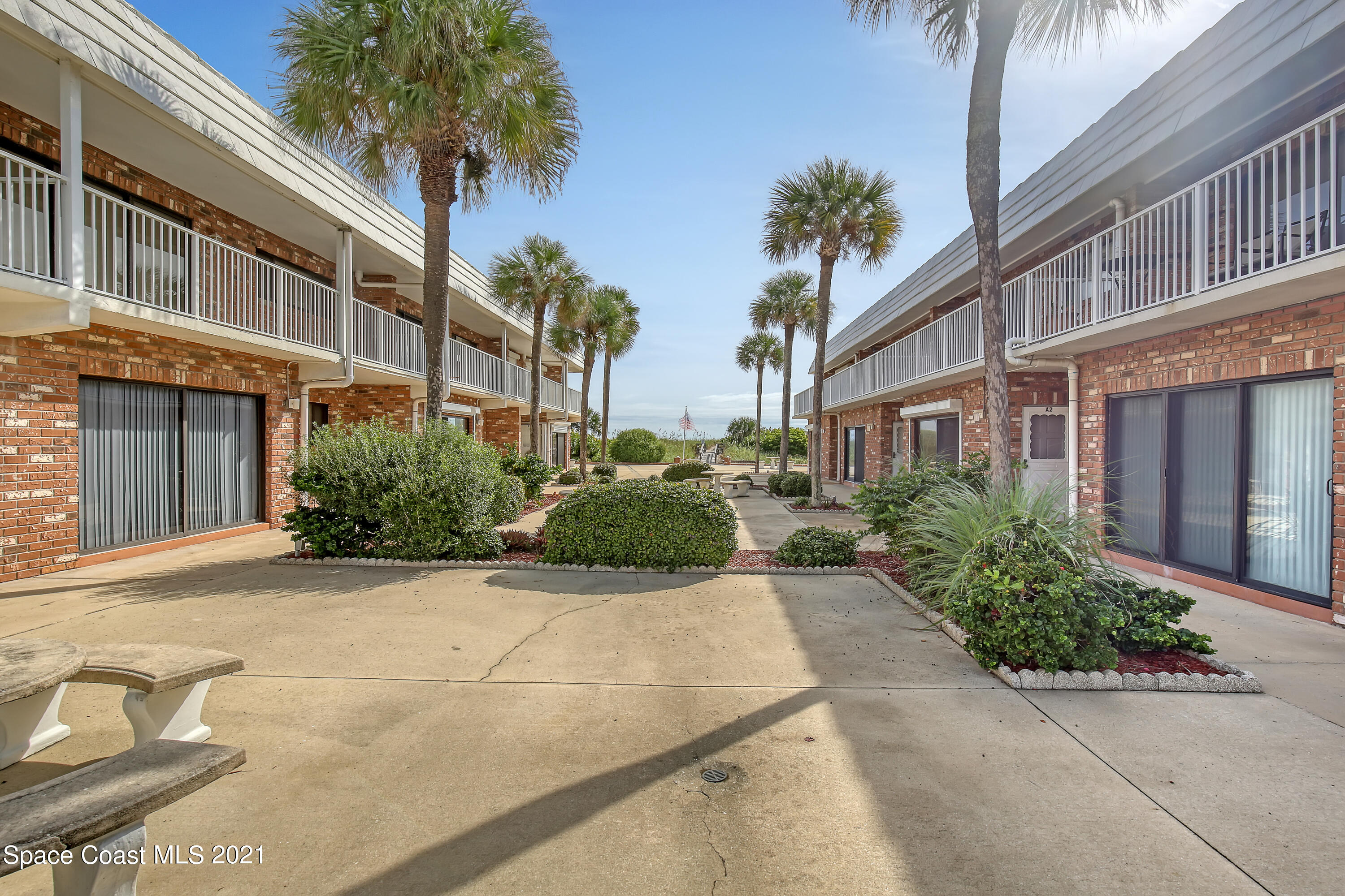 5000 Ocean Beach Boulevard, Unit C5 Cocoa Beach, FL 32931 - Photo 29 of 43 a view of a building with a yard