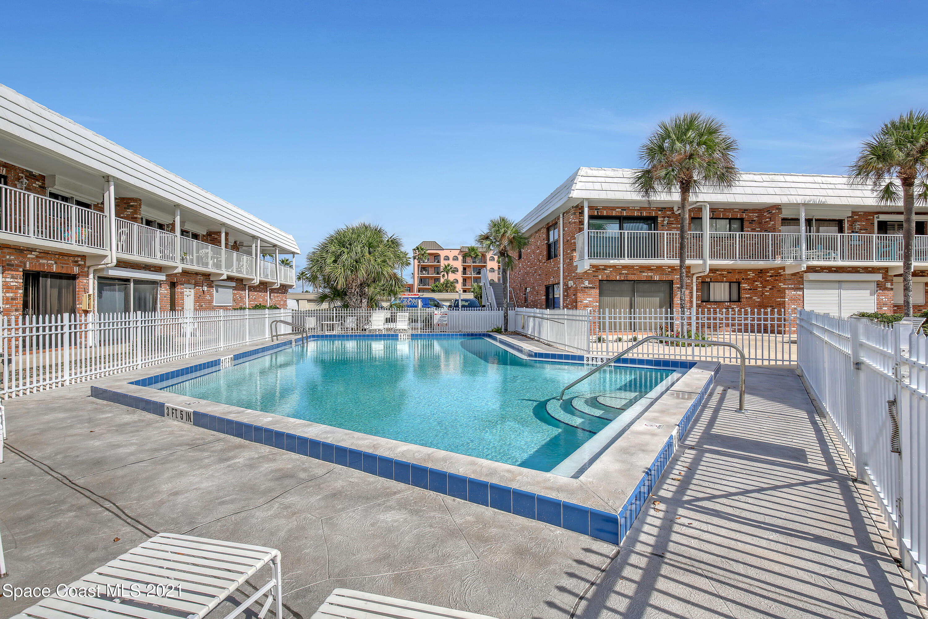 5000 Ocean Beach Boulevard, Unit C5 Cocoa Beach, FL 32931 - Photo 33 of 43 a view of houses with swimming pool