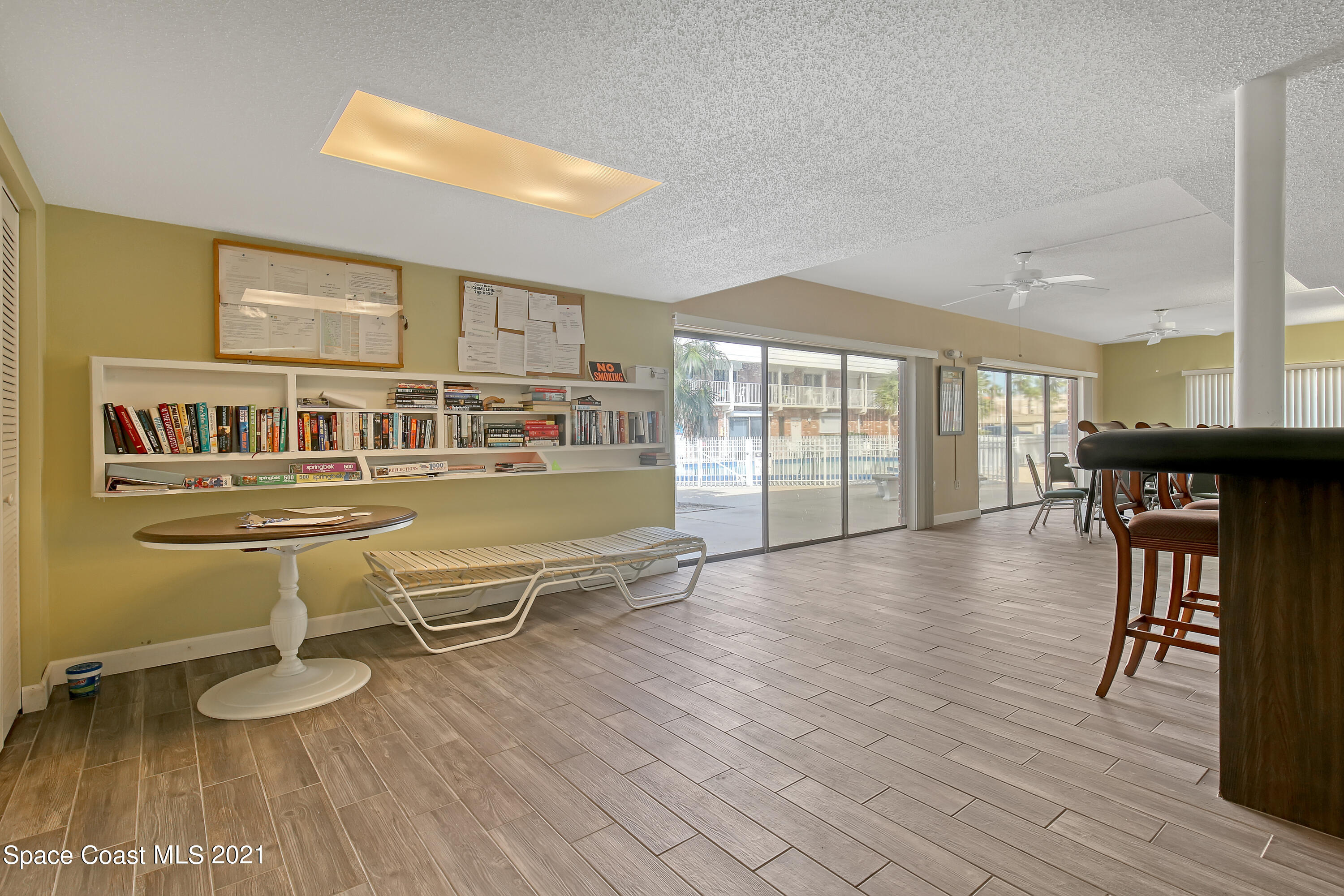 5000 Ocean Beach Boulevard, Unit C5 Cocoa Beach, FL 32931 - Photo 35 of 43 a living room with furniture a wooden floor and next to a window