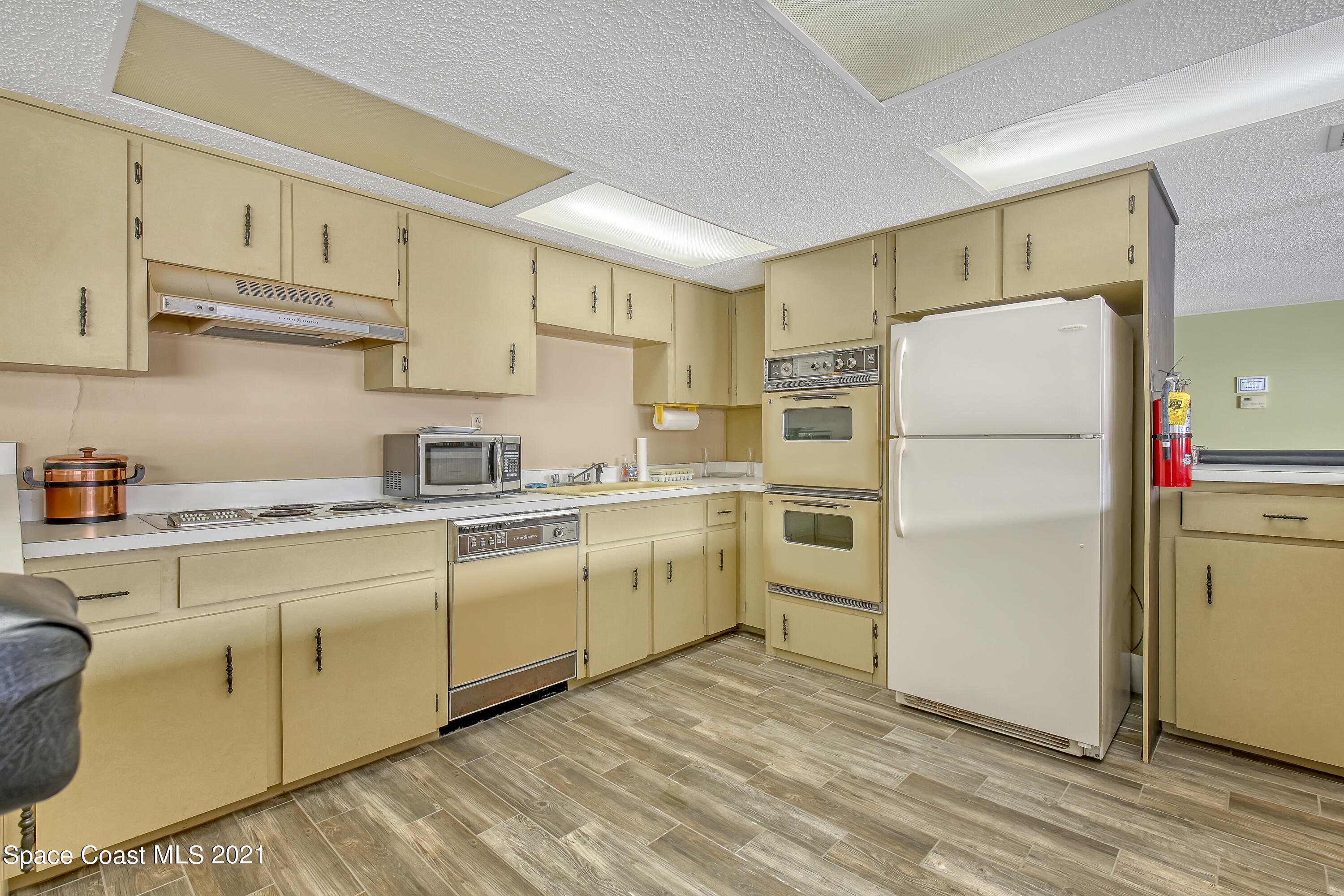 5000 Ocean Beach Boulevard, Unit C5 Cocoa Beach, FL 32931 - Photo 36 of 43 a kitchen with a refrigerator sink and cabinets