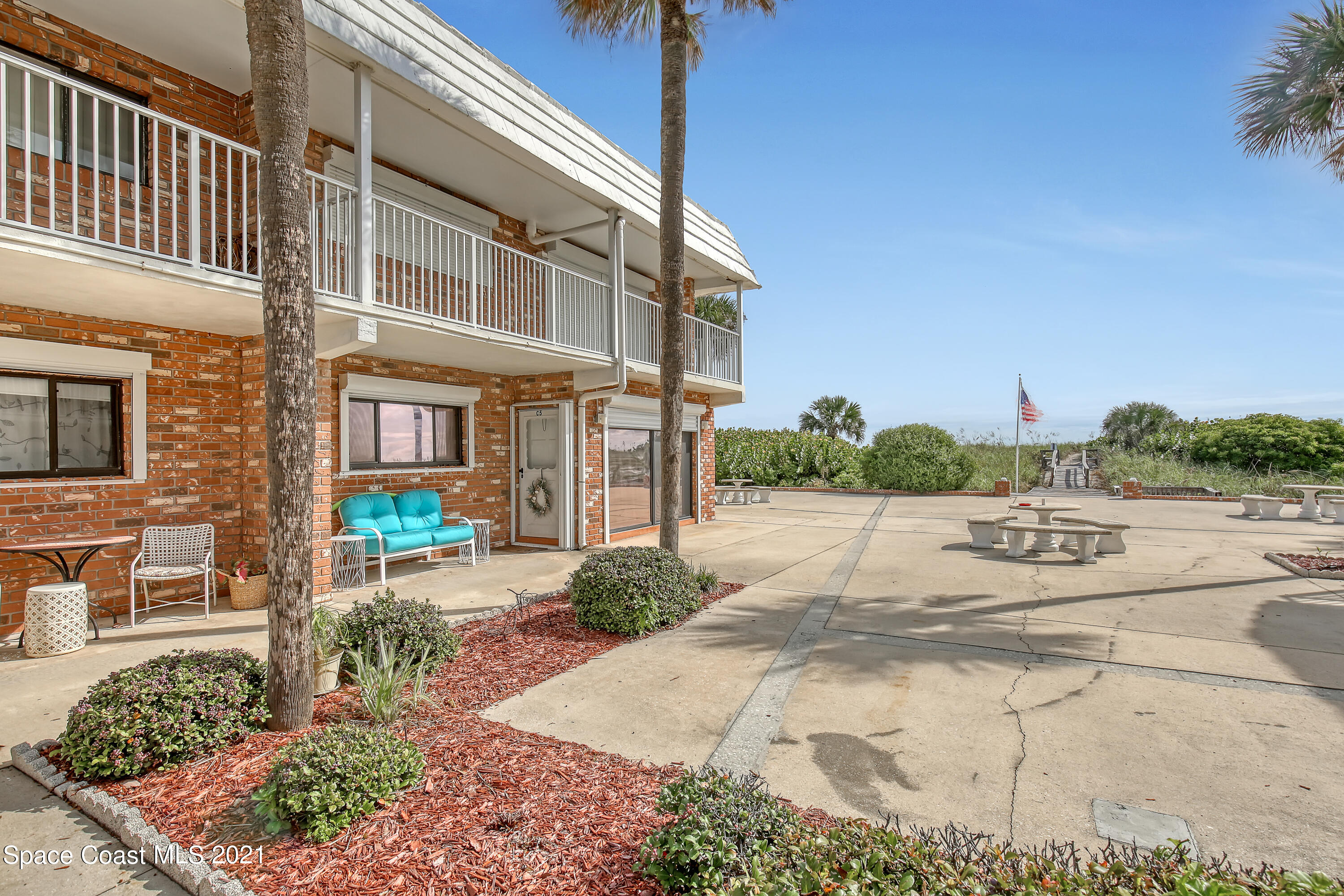 5000 Ocean Beach Boulevard, Unit C5 Cocoa Beach, FL 32931 - Photo 6 of 43 a view of a house with a yard