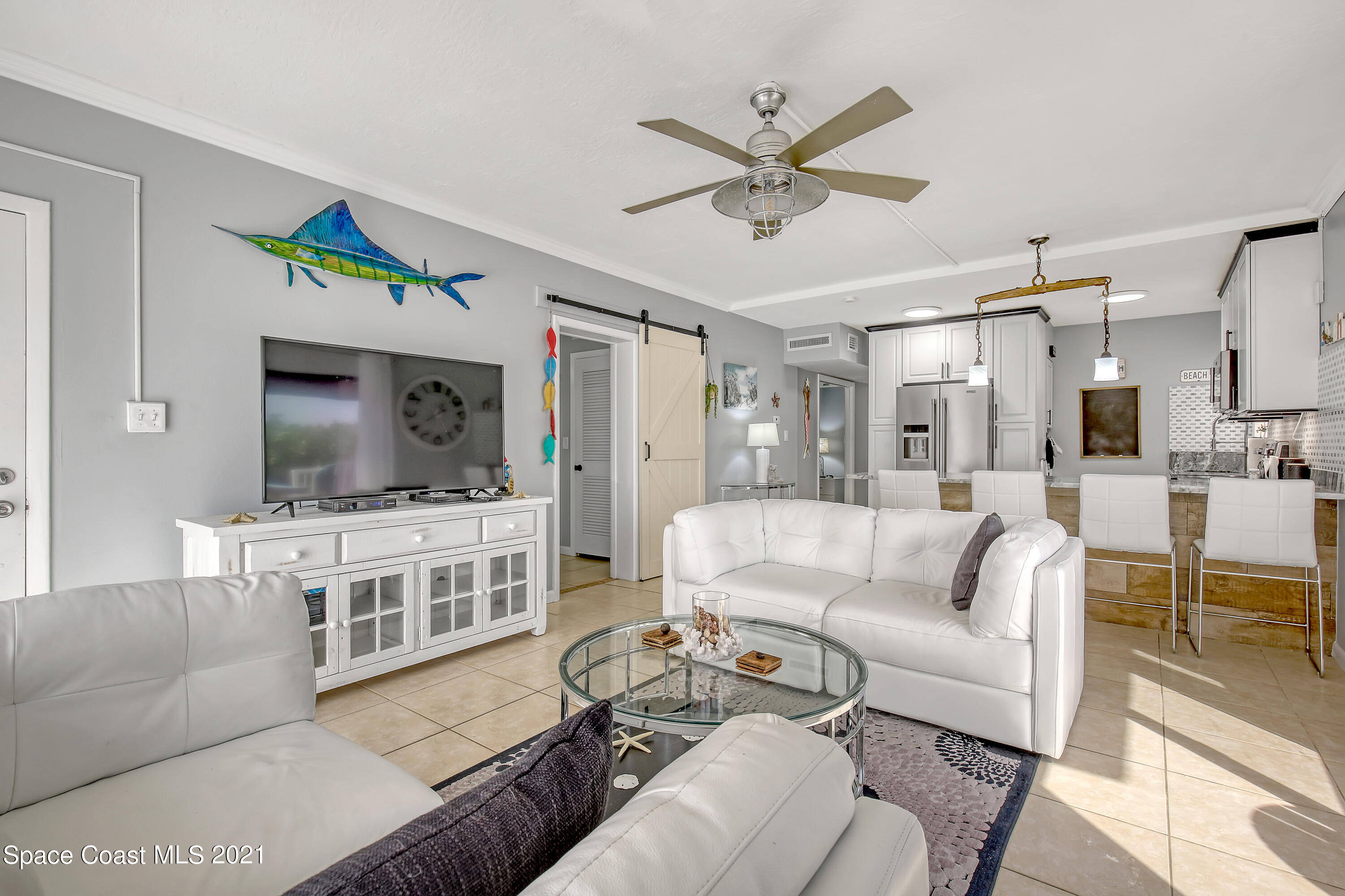 5000 Ocean Beach Boulevard, Unit C5 Cocoa Beach, FL 32931 - Photo 9 of 43 a living room with furniture and view of kitchen