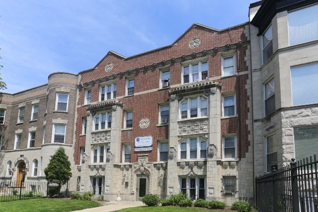 4735 North Beacon Street, Unit 307 Chicago, IL 60640 - Photo 1 of 15 a front view of a building with yard