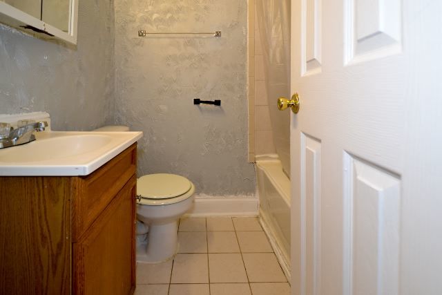 4735 North Beacon Street, Unit 307 Chicago, IL 60640 - Photo 13 of 15 a bathroom with a sink a toilet and shower