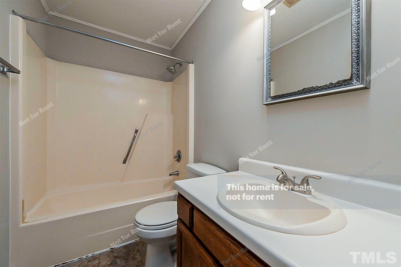 3622 Colchester Street, Unit 26 Durham, NC 27707 - Photo 6 of 16 a bathroom with a sink a toilet and shower
