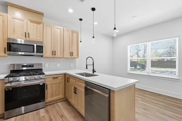 a kitchen with a sink stove and microwave