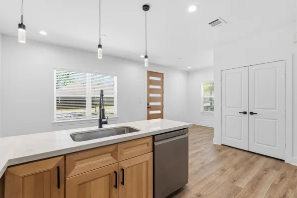 a kitchen with a sink appliances and a window