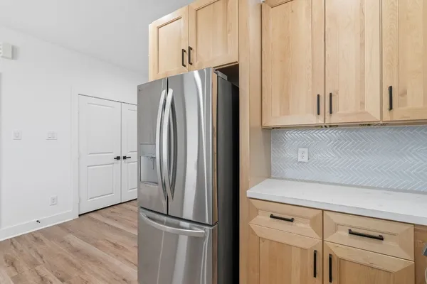 a kitchen with appliances and a refrigerator