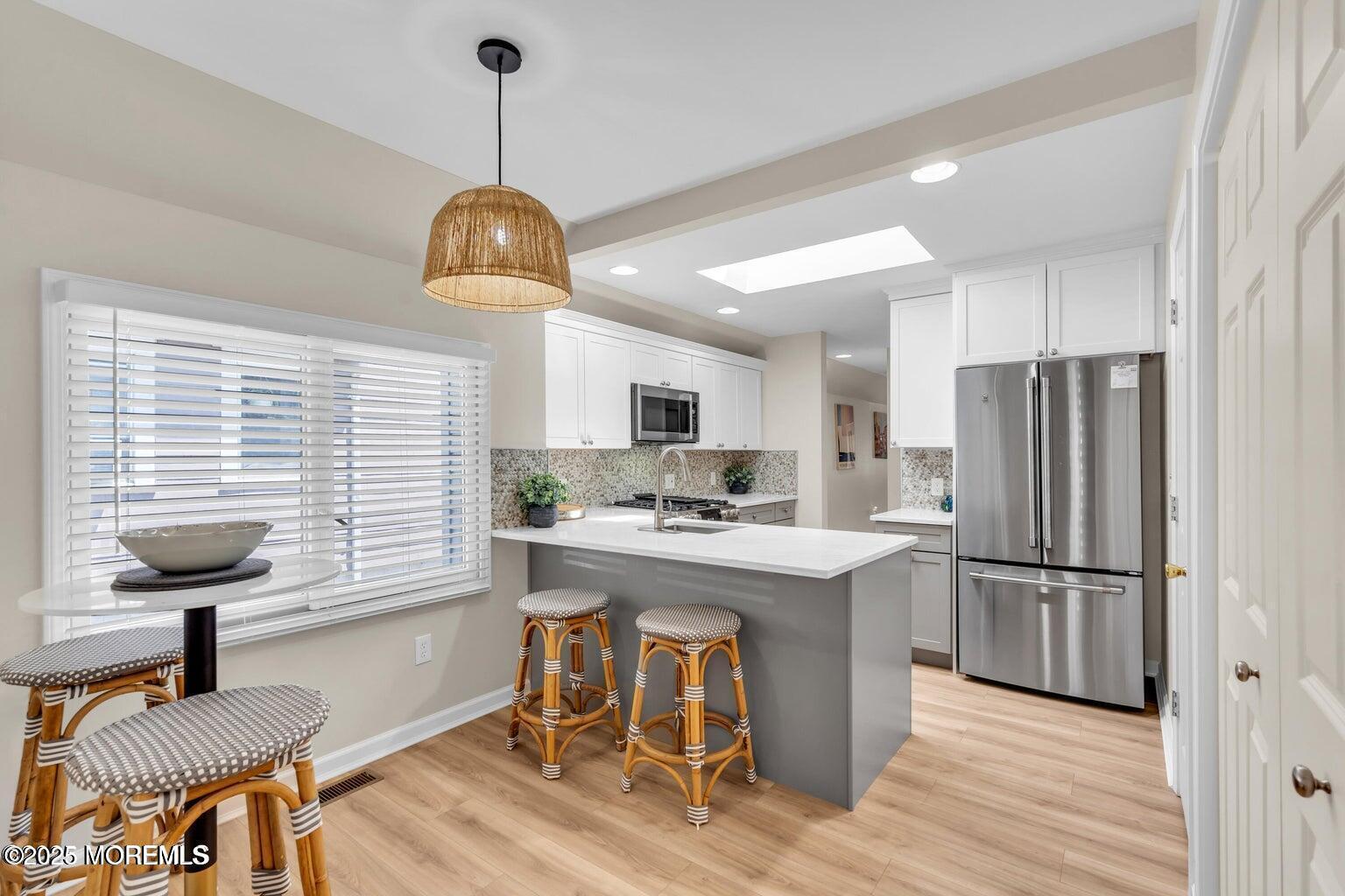 520 Brighton Avenue Spring Lake, NJ 07762 - Photo 13 of 25 a kitchen with stainless steel appliances granite countertop a stove refrigerator and a window