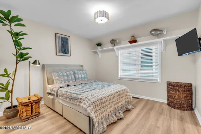 a bedroom with a bed and flat screen tv