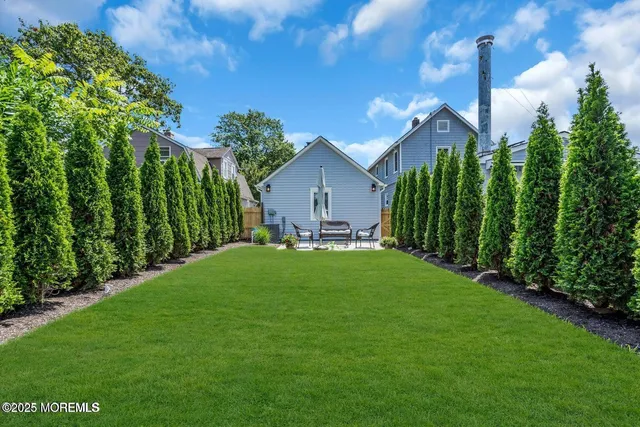 a view of a house with a big yard and potted plants