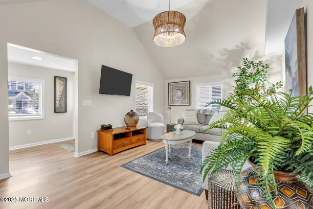a living room with furniture plant and a window