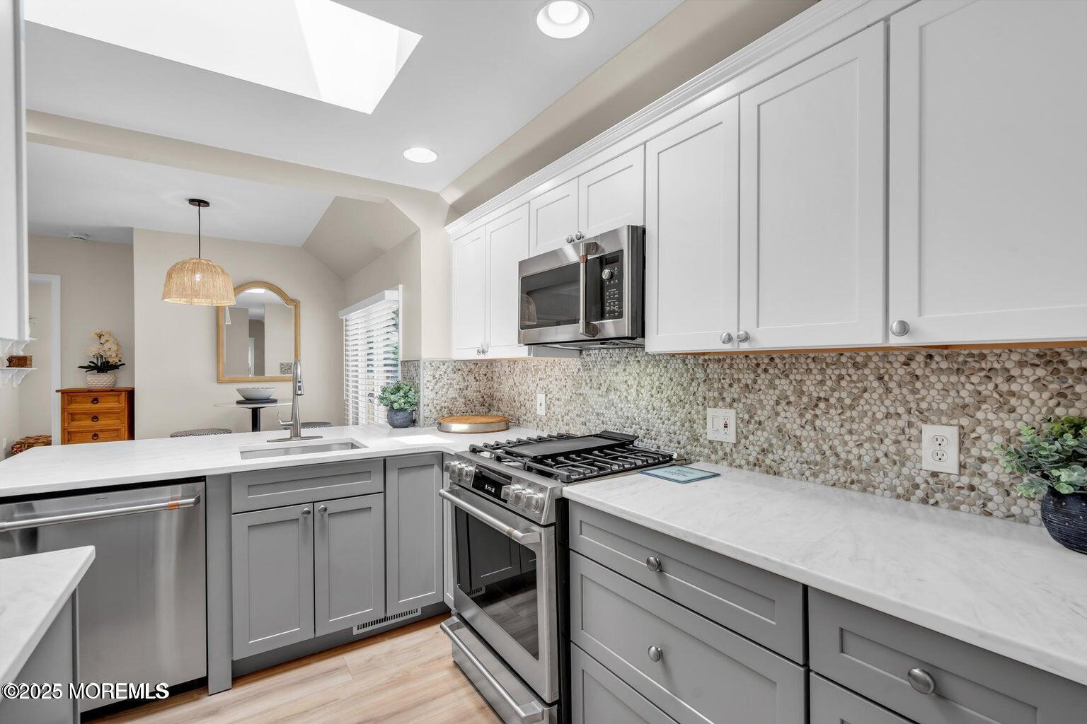520 Brighton Avenue Spring Lake, NJ 07762 - Photo 9 of 25 a kitchen with a sink stove and microwave