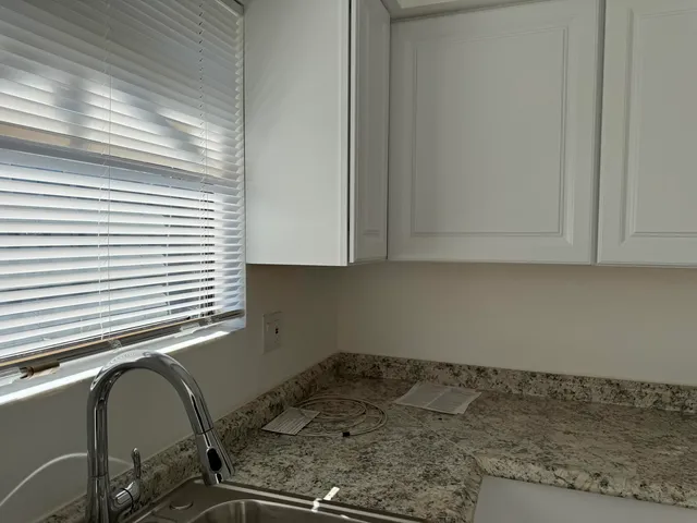 a utility room with cabinets washer and dryer