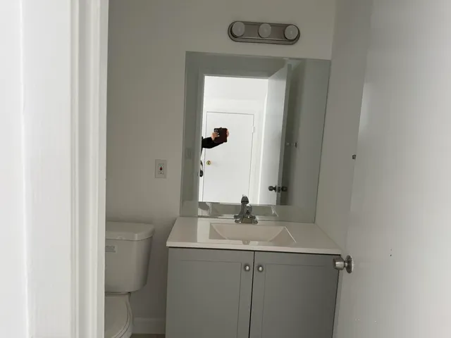 a white toilet sitting next to a sink