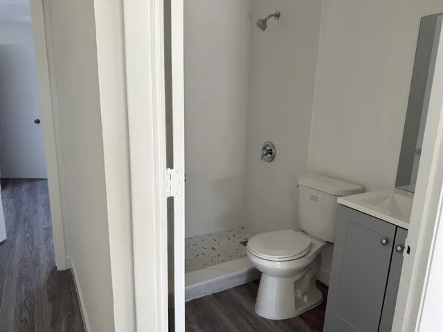 a white toilet sitting next to a bathroom sink