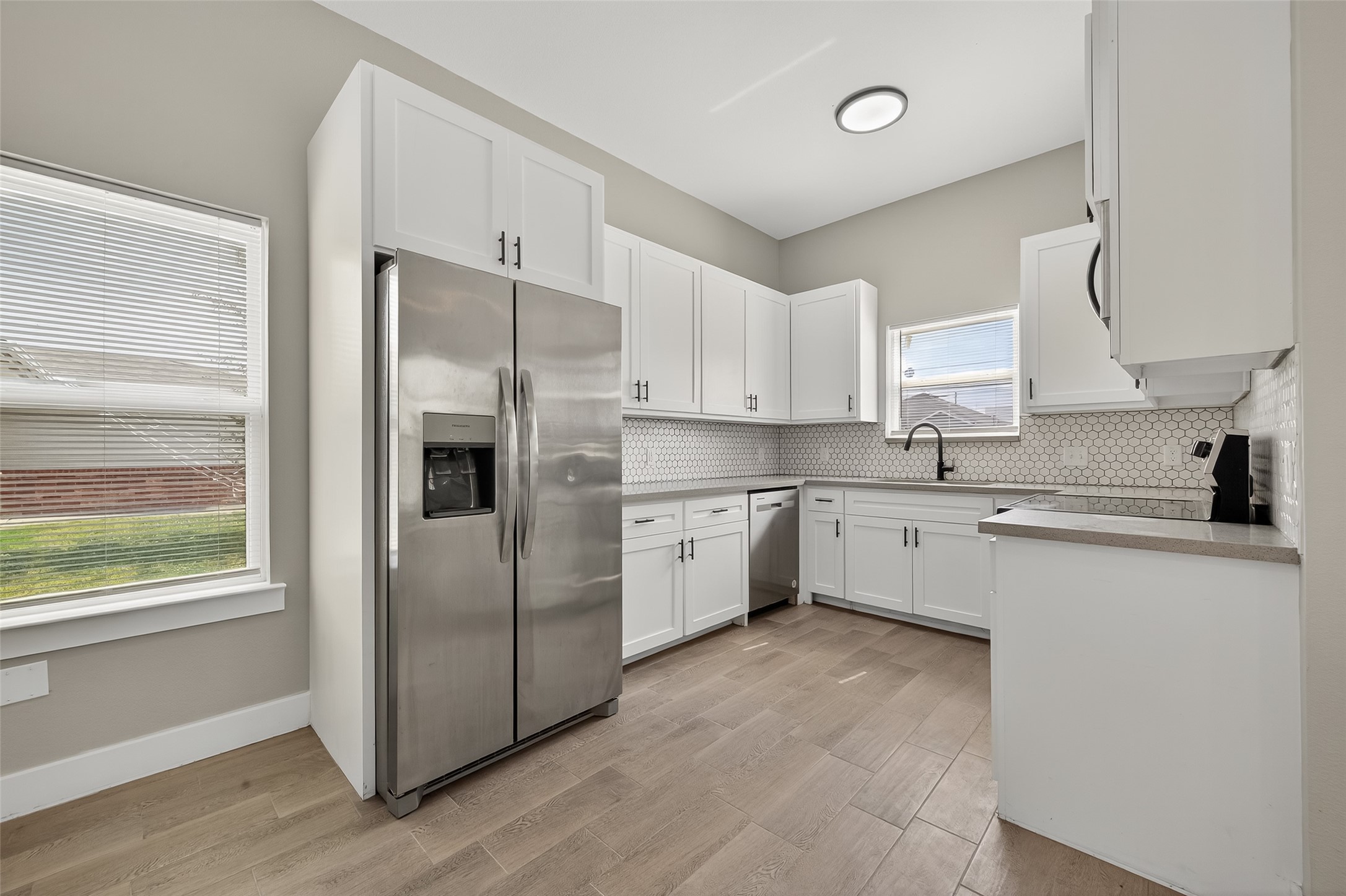 8005 Sexton Street, Unit B Houston, TX 77028 - Photo 13 of 43 a kitchen with stainless steel appliances a refrigerator sink and cabinets
