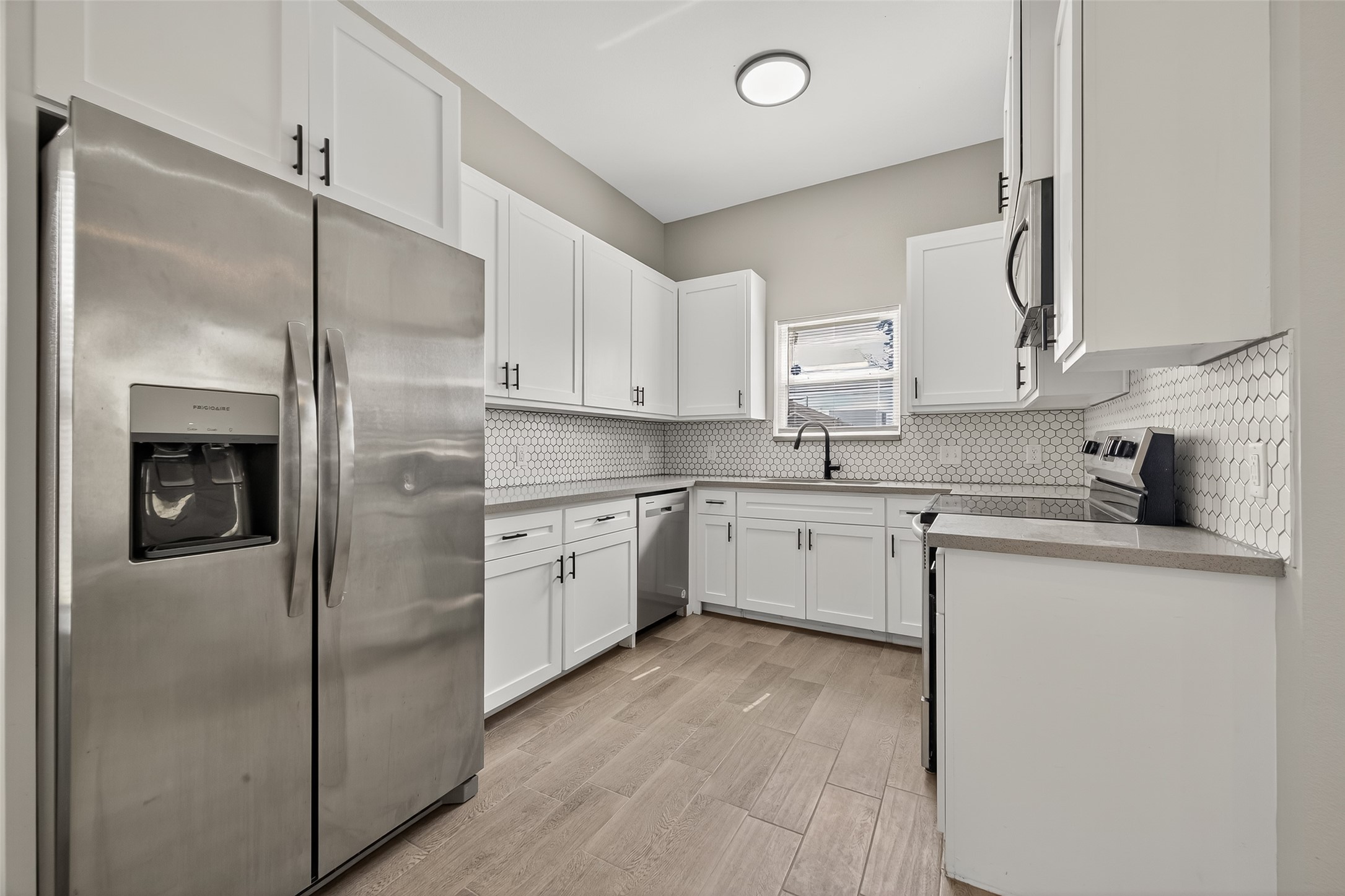 8005 Sexton Street, Unit B Houston, TX 77028 - Photo 14 of 43 a kitchen with a refrigerator sink and cabinets