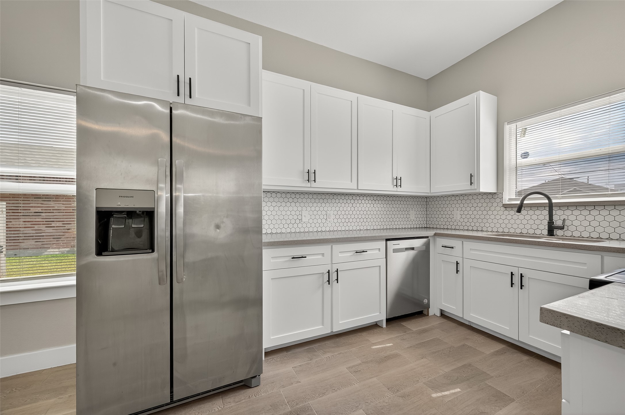 8005 Sexton Street, Unit B Houston, TX 77028 - Photo 15 of 43 a kitchen with cabinets and stainless steel appliances