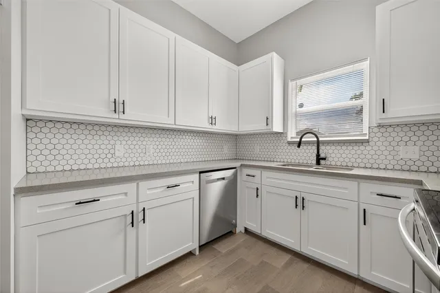 a kitchen with white cabinets and white appliances