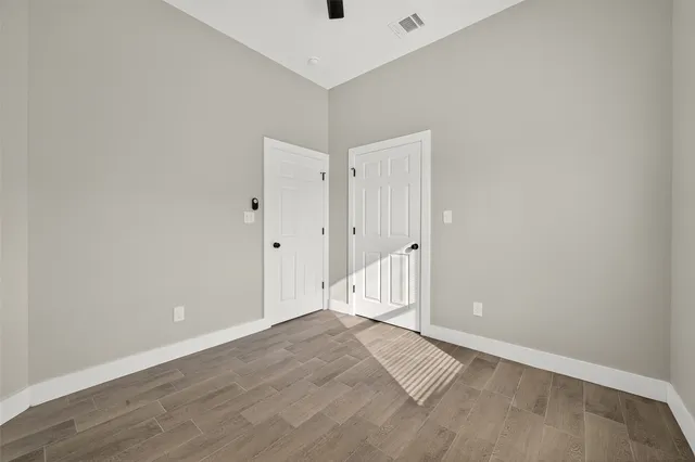 a view of a room with wooden floor